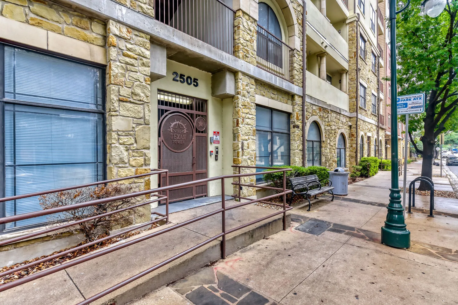 Apartment building with stone facade and gate