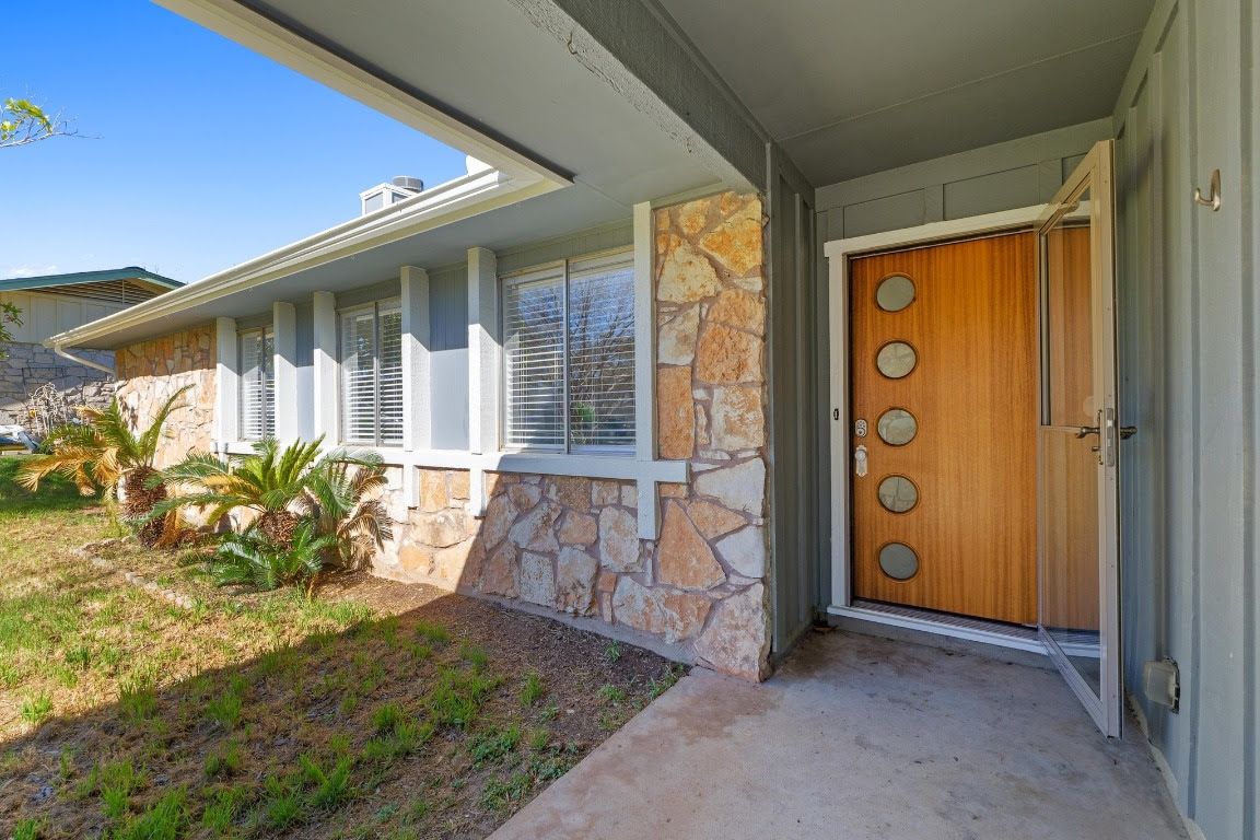 House with stone exterior and unique wooden door