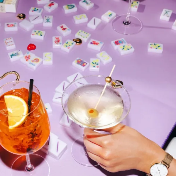 Cocktails and dominoes on purple table