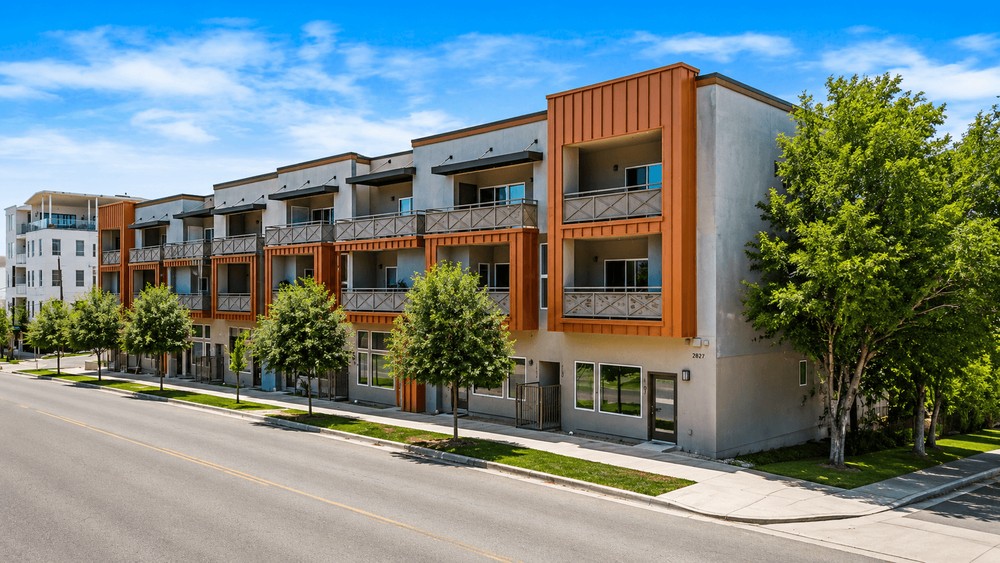 Modern apartment building with trees and blue sky