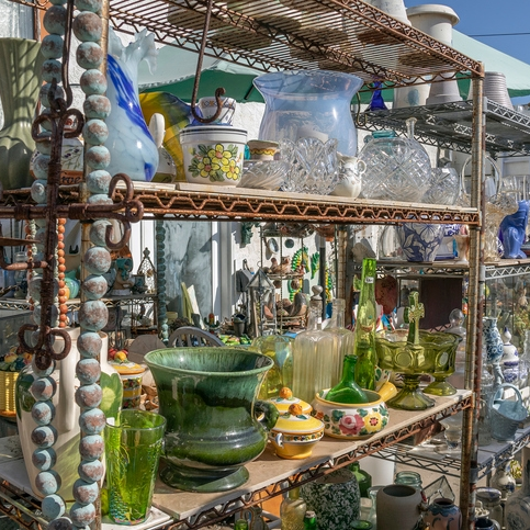 Vintage glassware and pottery on shelves