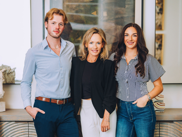 Three people smiling indoors