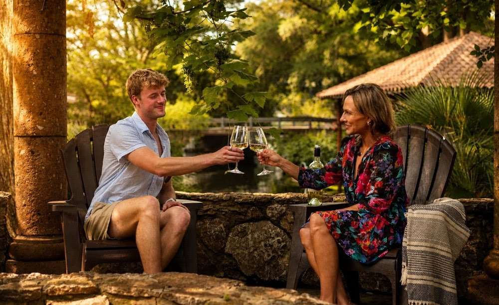 Couple toasting with wine glasses outdoors