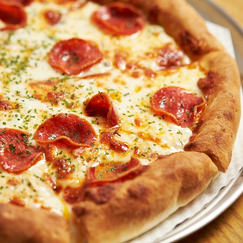 Pepperoni pizza with herbs on a tray