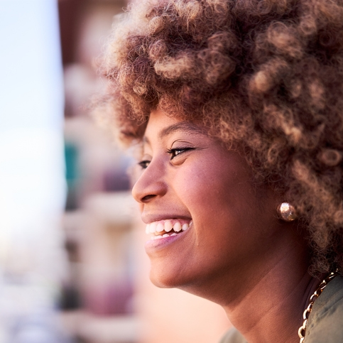 Rope Trix Smiling woman with curly hair in profile
