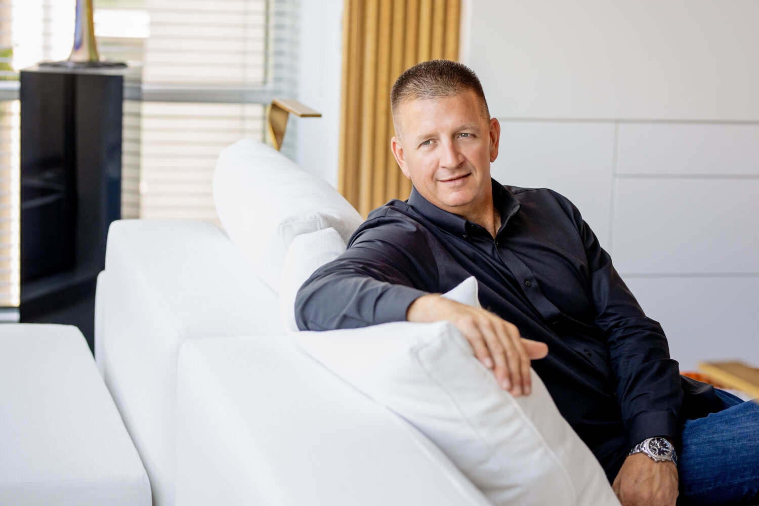 Man relaxing on a white sofa