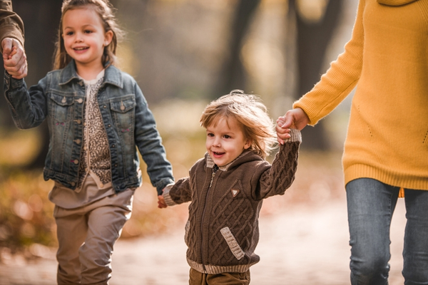 Happy children walking in autumn park