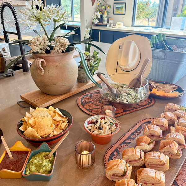 Southwestern buffet with sandwiches, chips, dips, and floral centerpiece