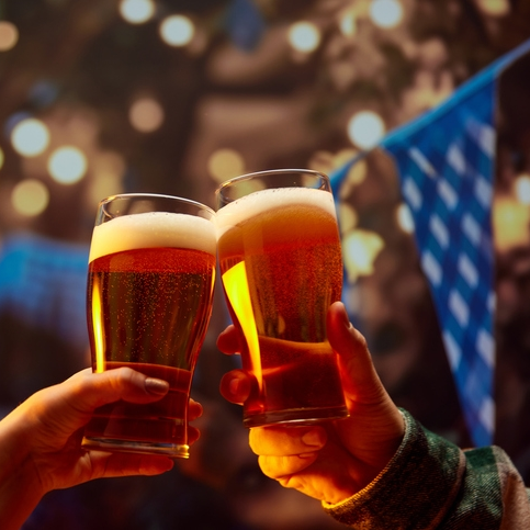 Two people toasting with beer at Oktoberfest.