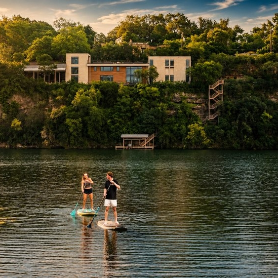 Two people paddleboarding on a lake