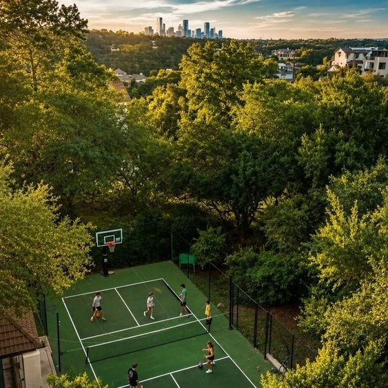 Outdoor basketball game with city skyline