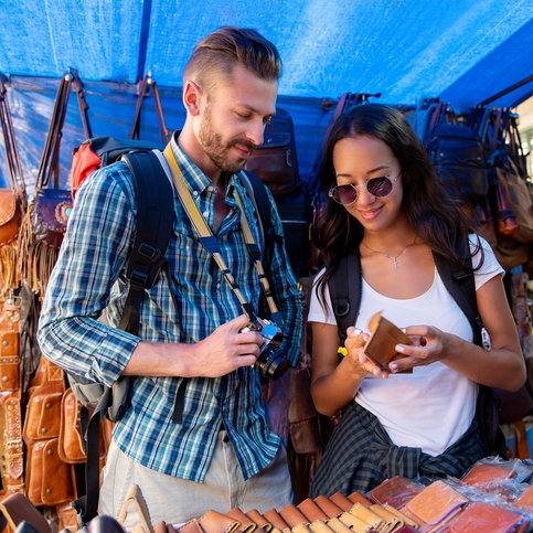 Couple shopping for leather goods at market