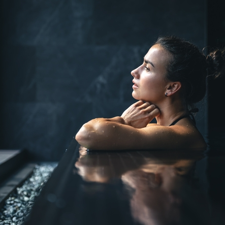 Woman relaxing in modern spa pool