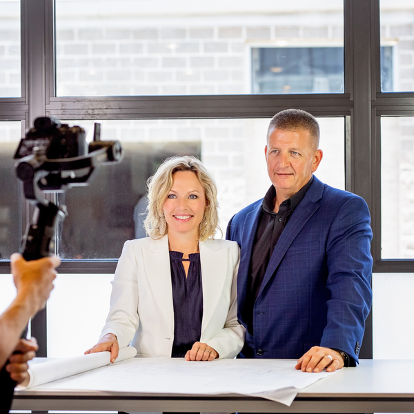Two professionals in formal attire at a table