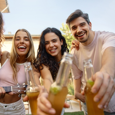 Group of friends enjoying drinks outdoors.