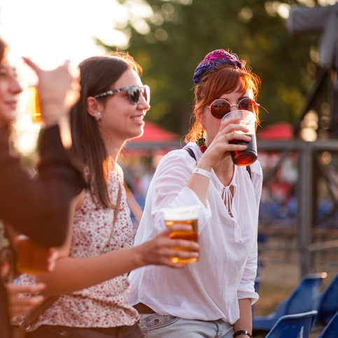 People enjoying drinks at an outdoor festival
