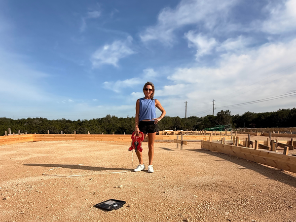 Person standing on construction site with tools.