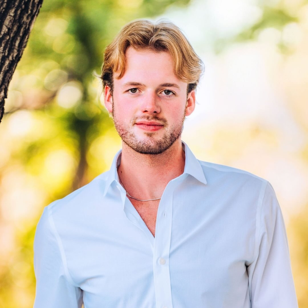 Young man in light blue shirt outdoors