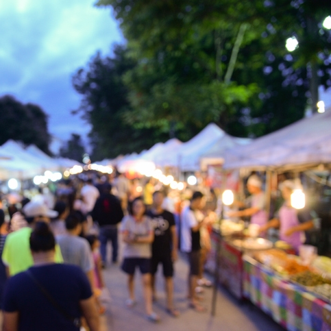 Rope Trix Crowded outdoor night market with illuminated stalls