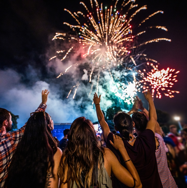 Crowd watching colorful fireworks at night