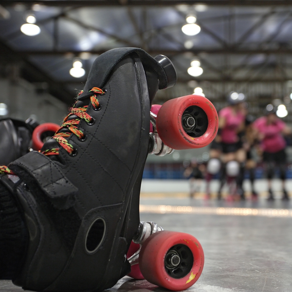 Rope Trix Black roller skate with red wheels indoors