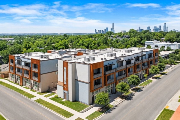 Modern apartment complex with city skyline in background
